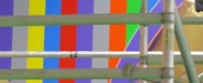 Scaffolding in front of a colourful contemporary art work 