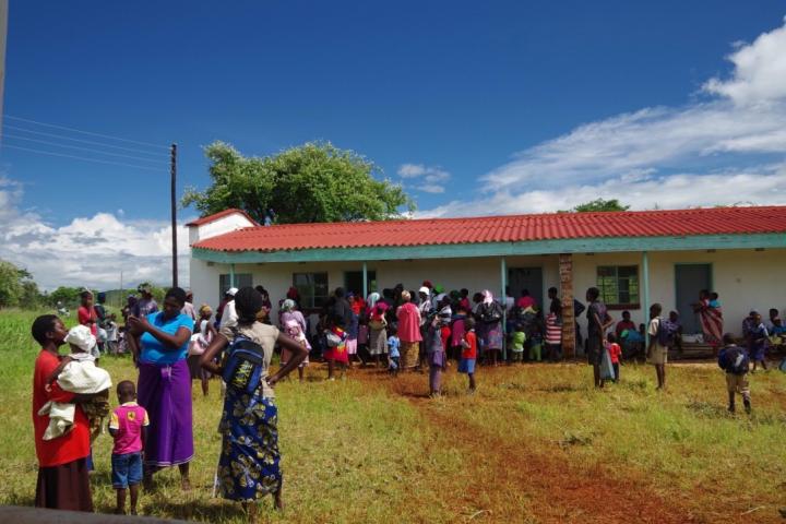 Photo of local villagers outside a building