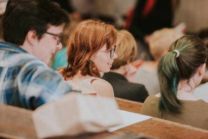 Shows a close up of students in a lecture theatre.