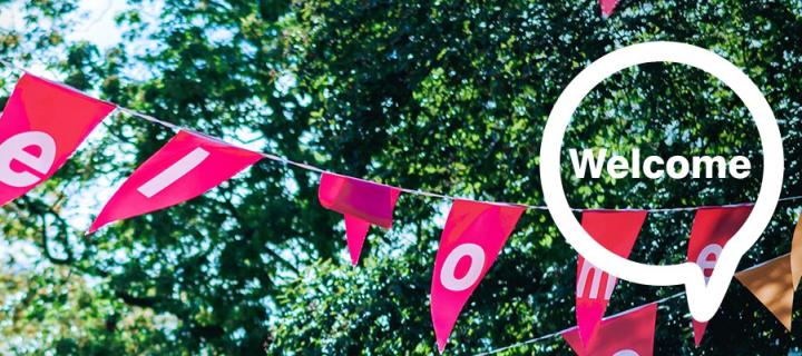 Red bunting with lettering in front of trees