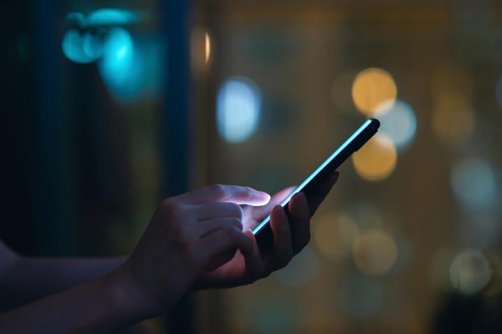 Stock image of person using their mobile phone