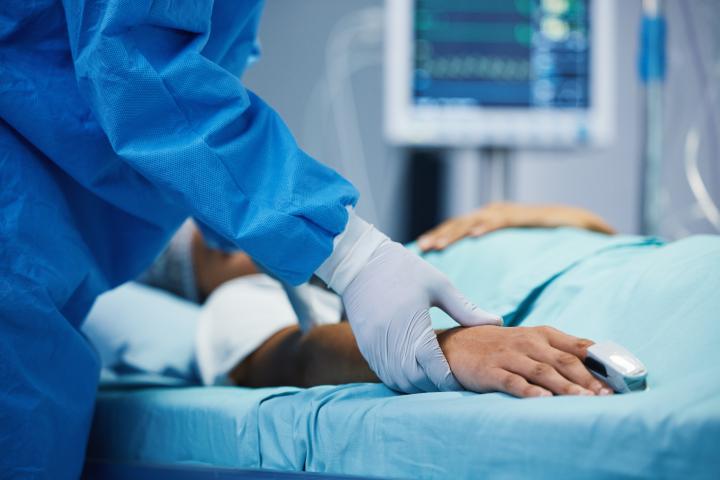 A medical professional cares for a patient in a hospital
