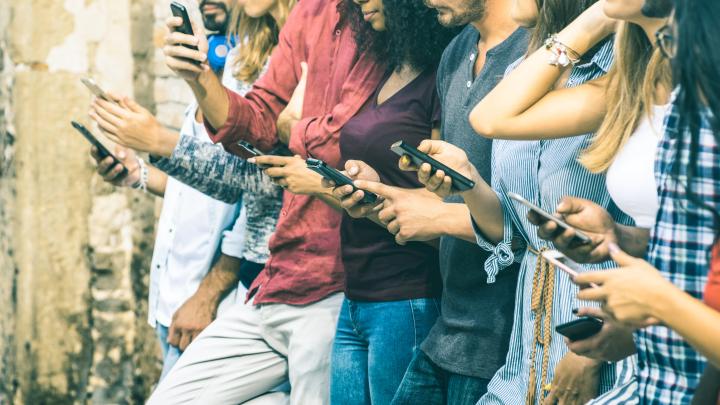 group of young people using apps