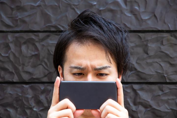 A man looks at his phone