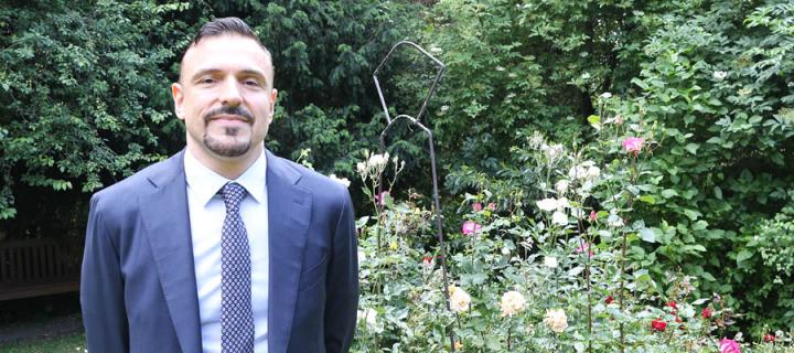 Giuseppe photographed in a garden.