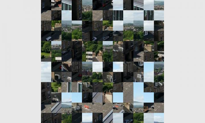 An image scrambled into 144 tiles. Light blue, green, white, grey and brown tones.