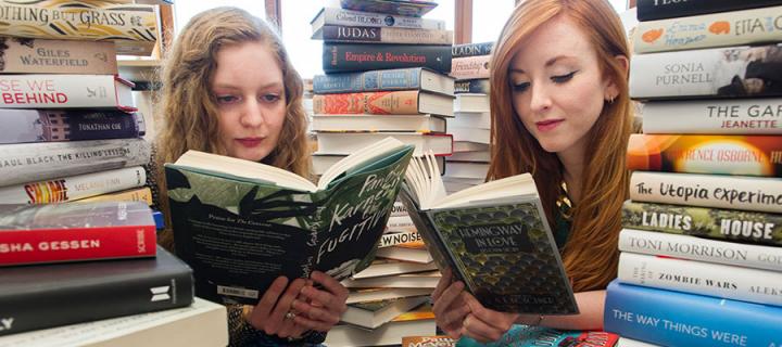 Photo of The James Tait Black Prize co-ordinators Mhairi Morrison and Rosaleen Nolan, both reading books