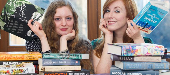 Photo of The James Tait Black Prize co-ordinators Mhairi Morrison and Rosaleen Nolan, both reading books