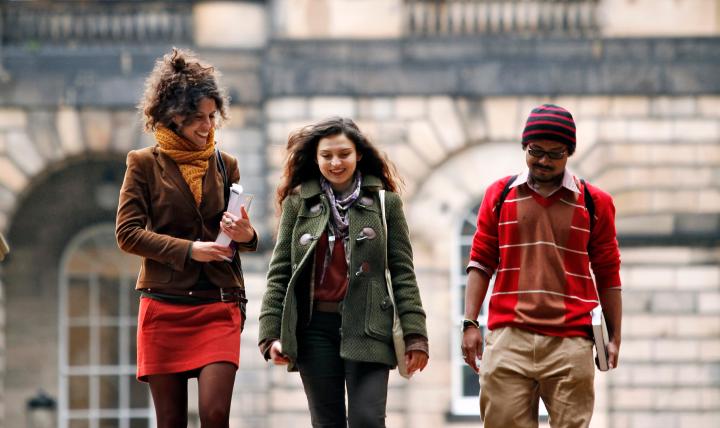 Three students walking down the steps at Old College Quad