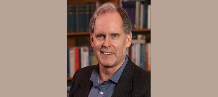 Robert Morrison in front of a bookshelf