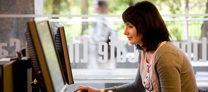 Photo of a student on computer in the library café