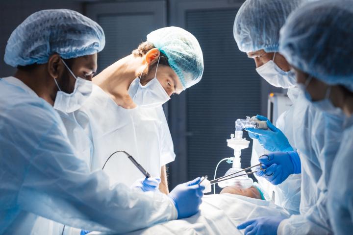 Surgery team working on a patient in an operating theatre