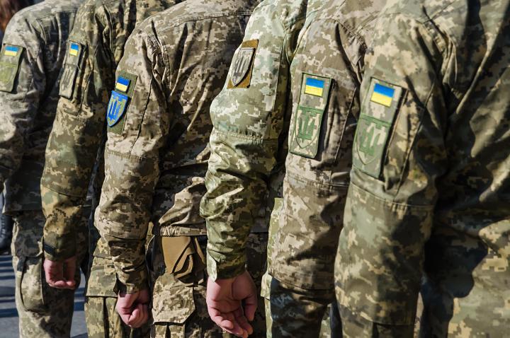 Ukrainian soldiers on military parade. Ukrainian flag on military uniform.