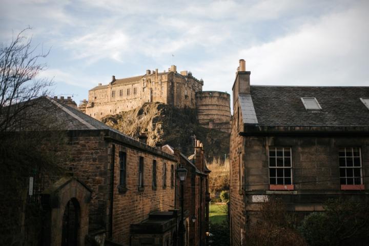 View of Edinburgh castle slightly obscured with buildings in front.