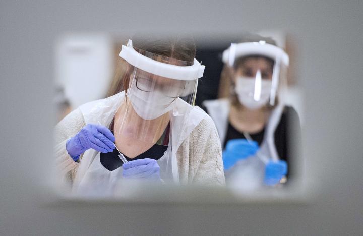 A member of the University of Edinburgh test centre staff processing the test immediately after the test is completed.