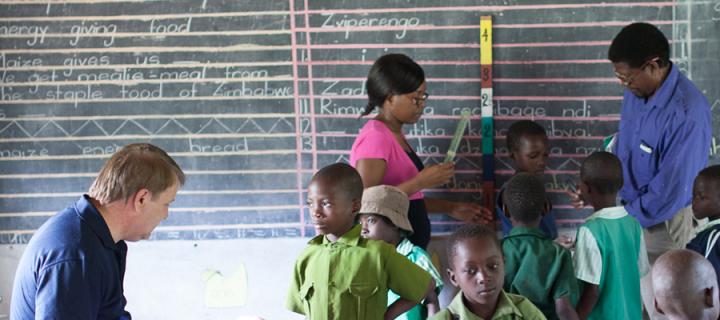 Researchers work with children in a classroom