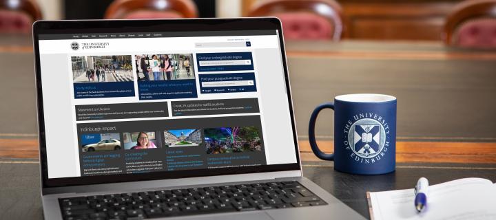 Laptop displaying University of Edinburgh website beside University-branded mug