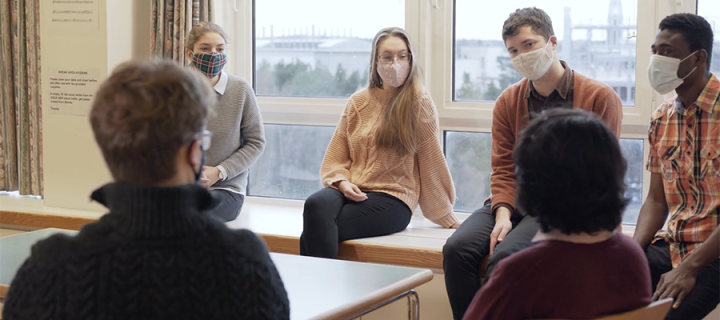 photo of icm phd students sitting in agroup, wearing face masks