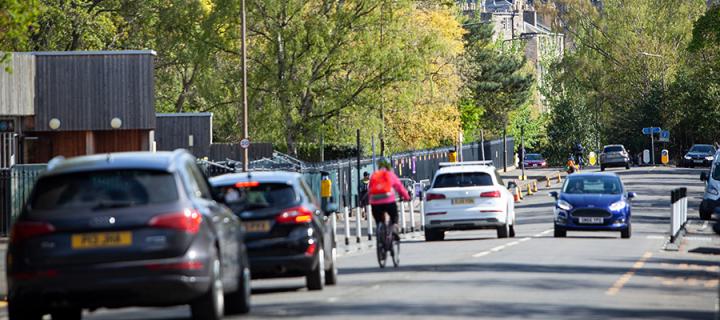 Vehicles and a cyclist in central Edinburgh