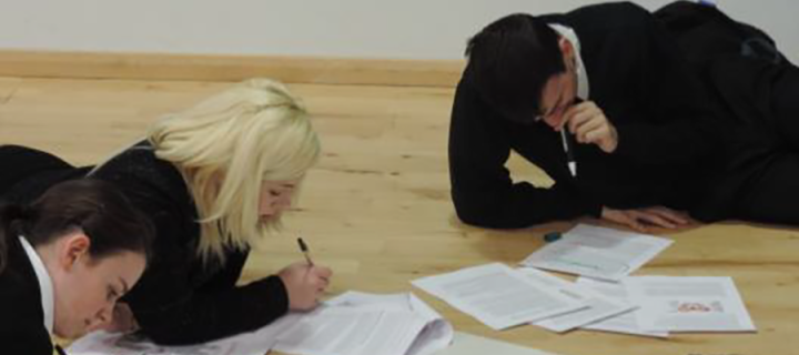 3 students working on worksheets at talk