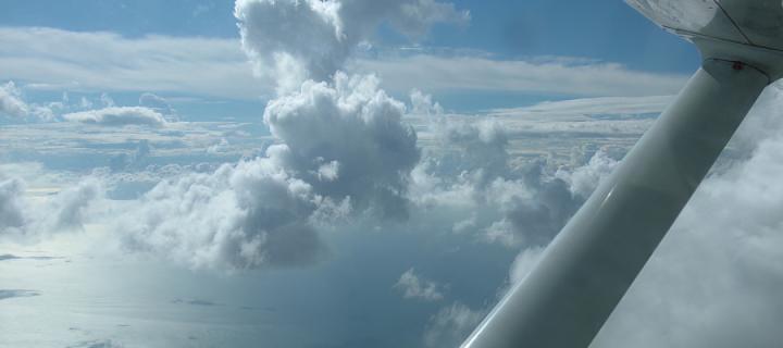 view from the window of a Cessna aircraft of passing clouds