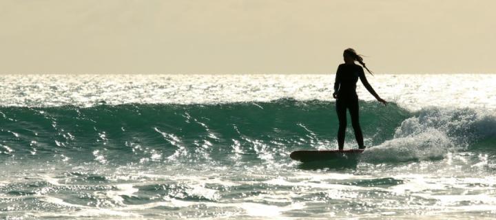 Surfer going on a gentle wave
