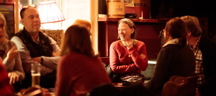 Audience laughing at bilingual storytelling night. 