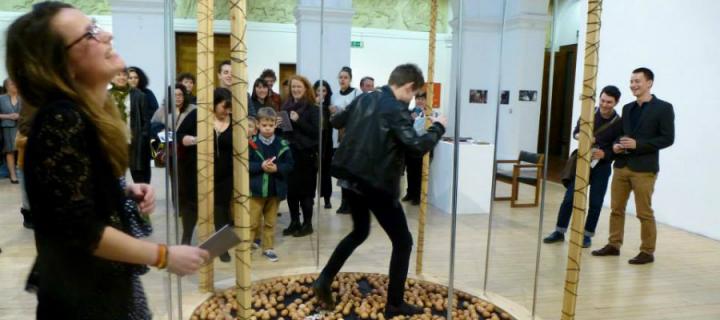 Audience interacting with artwork at exhibition.