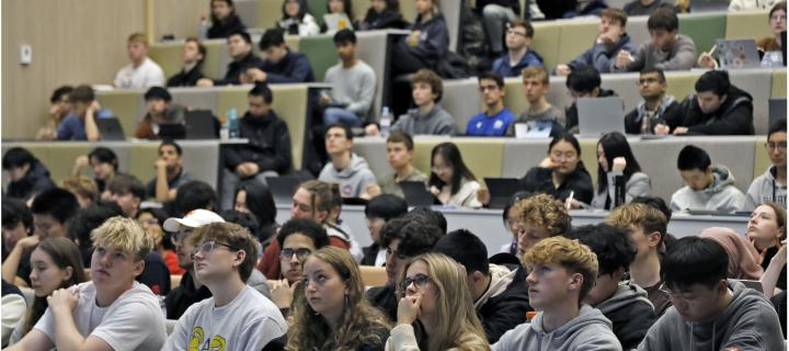 A lecture theatre full of students seen from the point of view of a lecturer.