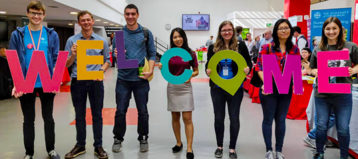 Students holding welcome letters