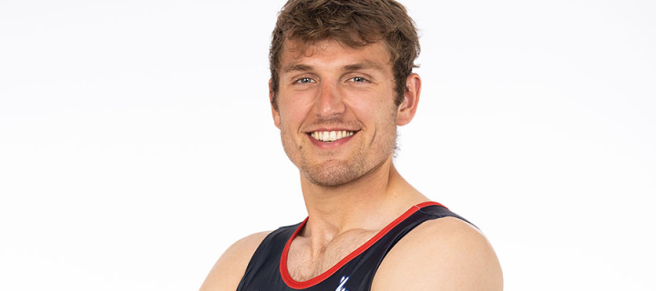 A portrait of graduate and Olympian Oli Wilkes against a white background