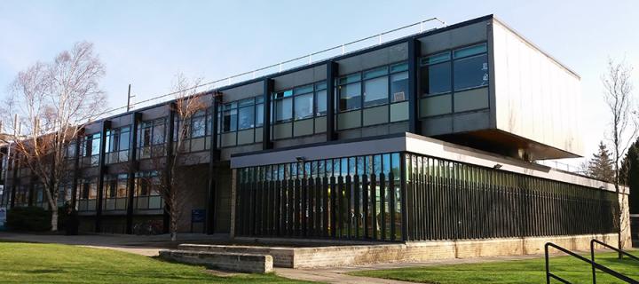 Photo of the Roger Land building in winter. The sun is shining and long shadows fall across the building's facade.