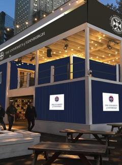 Animation of a soon-to-be building. It has navy blue walls and is open plan on the top level, with strings of lights hanging.