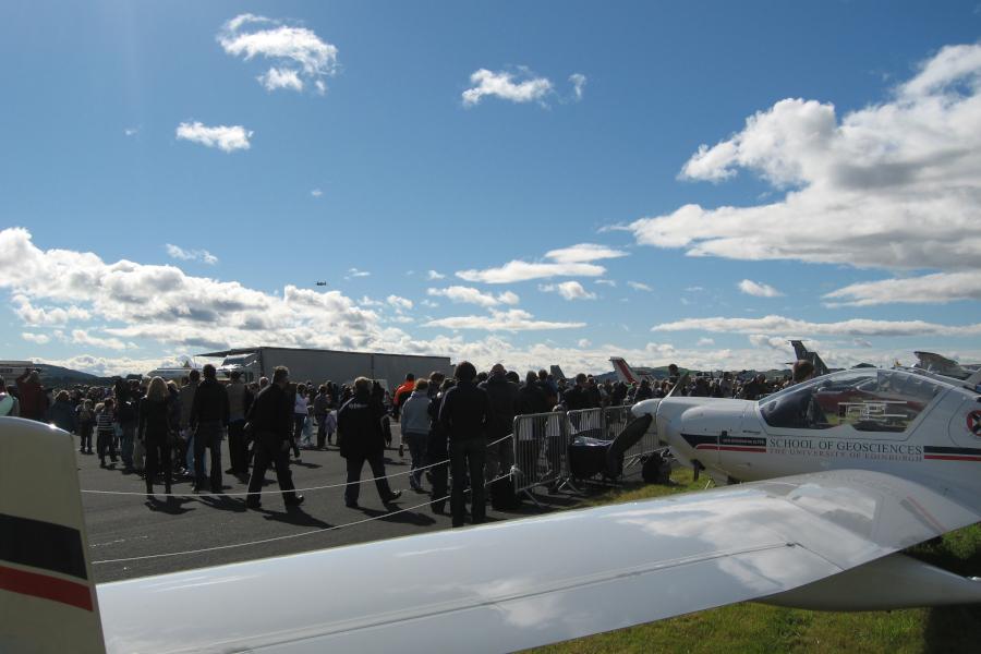 Dimona aircraft on ground display at an airshow with crowd in front