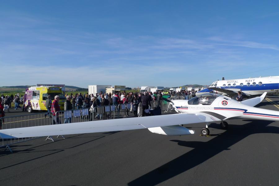 Dimona aircraft on ground display at an airshow with crowd in front