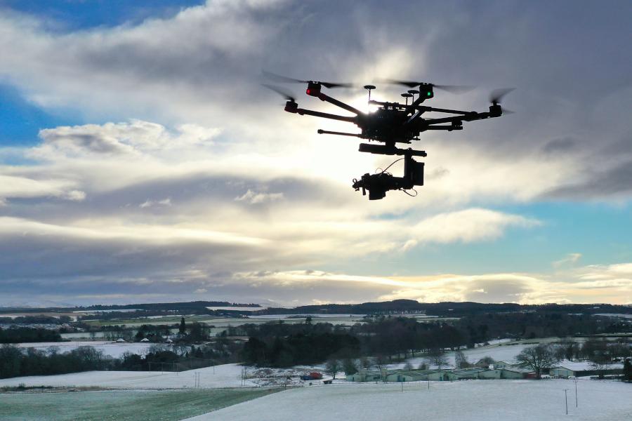 M600 Pro drone in flight with sunset behind