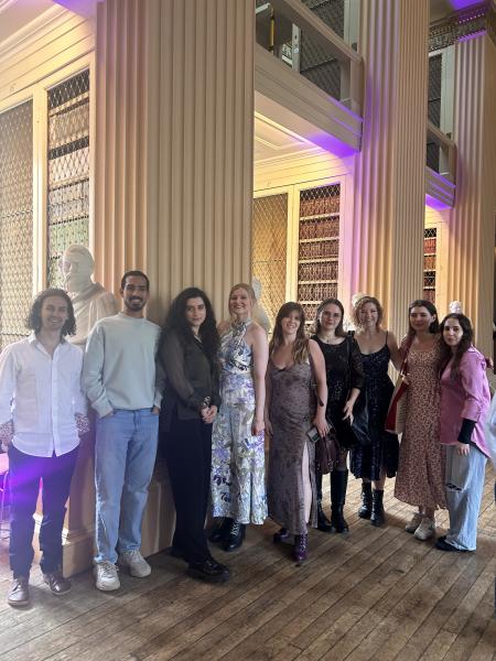 A group of postgraduate students gather in Playfair Library
