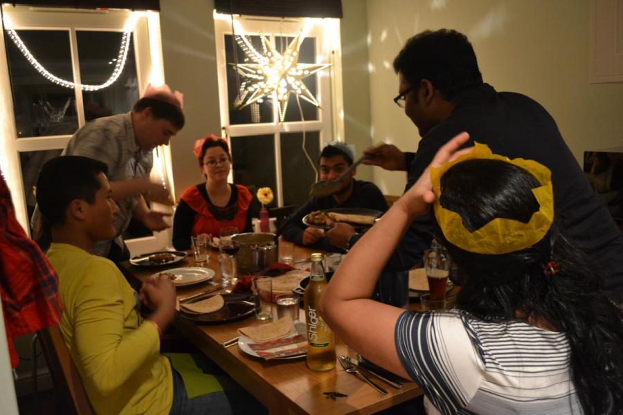 Lab group members sit around a dining table in a room decorated for Christmas