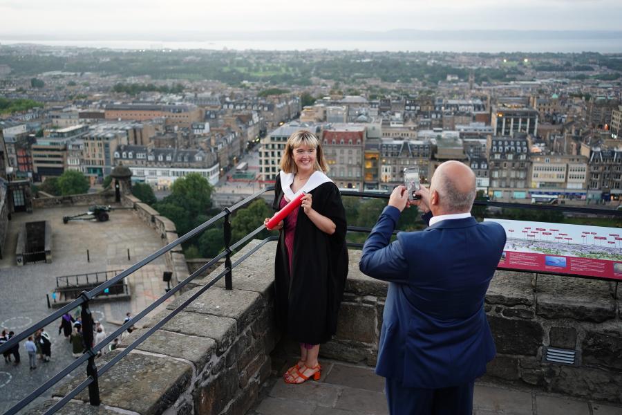 Guests taking photos on the castle ramparts overlooking the city