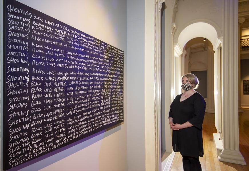 Larry Achiampong. Detention. Blackboard, chalk. Pictured – Melissa MacRobert, Exhibitions Manager at Talbot Rice Gallery