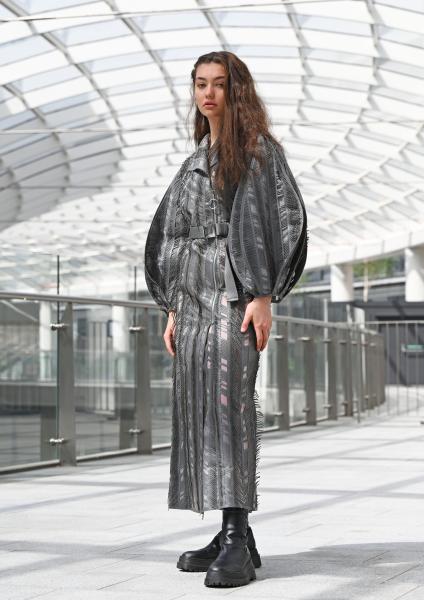Model poses in fashion outfit