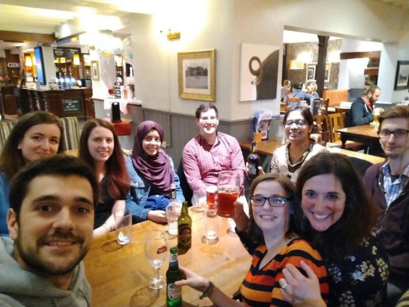 Group photo, all members sitting around a table