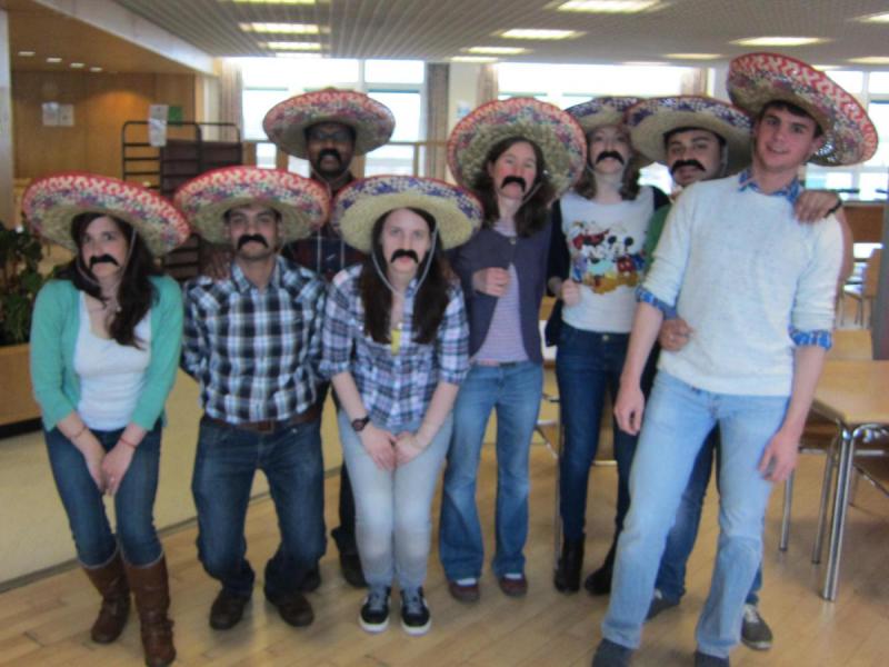 Lab group members in somreros with large fake mustaches