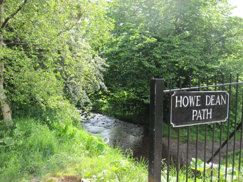 Phot of a sign saying 'Howe Dean Path' in front ofa path leading into forest