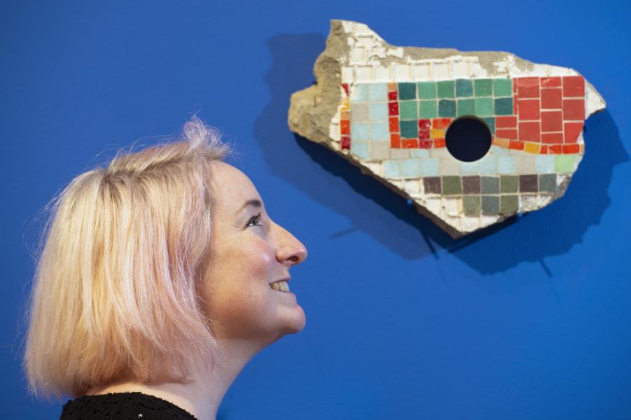 Side profile of a person stood in front of an exhibition piece by artist Stephanie Mann